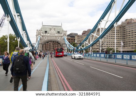 LONDON - 2015 AUGUST 5 : There is heavy traffic everyday in London.  Thousands cars, taxis, buses and pedestrians crossing River Thames on Tower Bridge.
