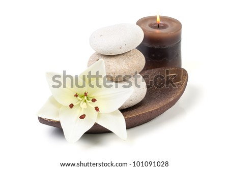 spa decoration with stones, candle and madonna lily on a white background