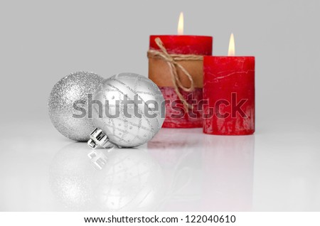 Christmas decoration with red candles and silver christmas balls