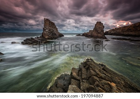 Stormy sea at sunrise - rock formation 
