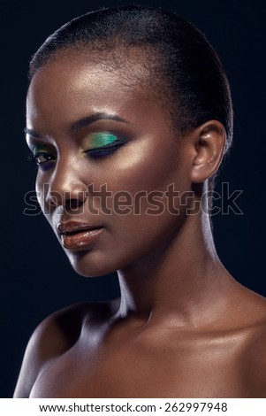 Beauty portrait of handsome ethnic african girl, on dark background