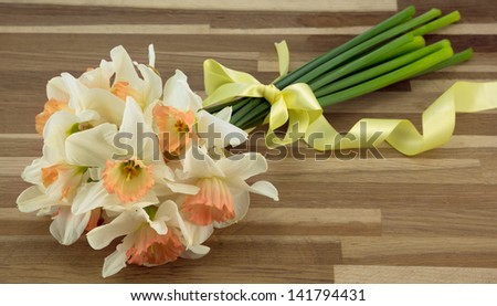 Bunch of daffodils tied with a yellow ribbon.
