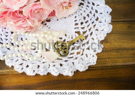 roses with pearls and key on retro crochet doily