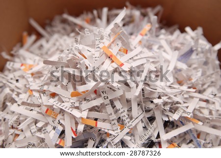 Pile of shredded paper with business words showing.Security content.