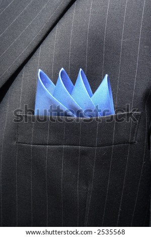 Blue handkerchief inside a pinstriped suit breast pocket