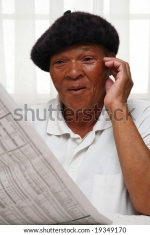 Ethnic woman reading the paper and looking surprised