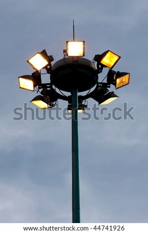 Security lights on top of a tall steel mast