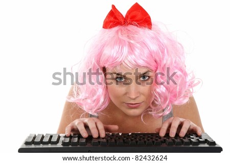 Pretty fun girl in a pink wig addicted to internet and typing on keyboard