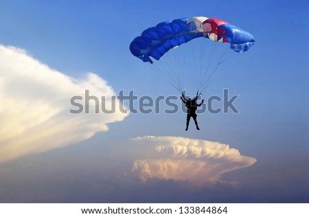Parachute landing on stormy sky background.