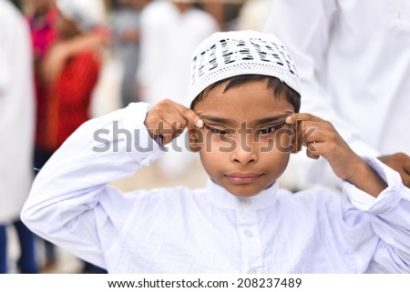 AHMEDABAD, GUJARAT/INDIA - 29TH TUESDAY JULY 2014 : Unidentified Muslim boy making funny faces on  Eid al-Fitr  in Jama Masjid,Ahmedabad, India.