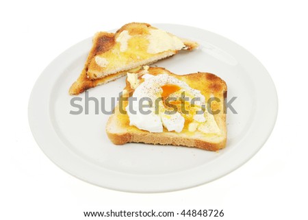 Poached egg on toast on a plate isolated against white
