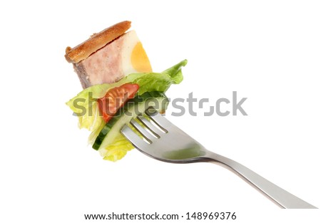 Pork and egg gala pie and salad on a fork isolated against white