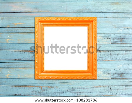 Orange Vintage picture frame, wood plated, blue wood background, clipping path included