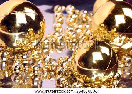 Golden decorations for Christmas tree are shiny.