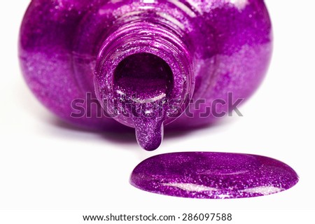 The spilled purple nail polish is on white background.