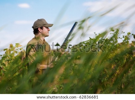 Young hunter camouflaged in dense vegetation during a hunting party