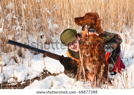 Hunter and his dog waiting for the hunt to show. Trained dog waiting to retrieve the prey