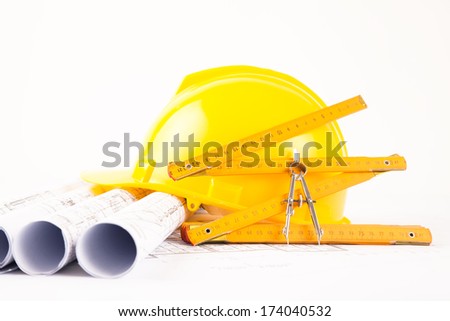 Architect rolls and plans and yellow helmet