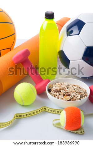 Sport equipment, energy drink, cereal bowl and centimeter - close up