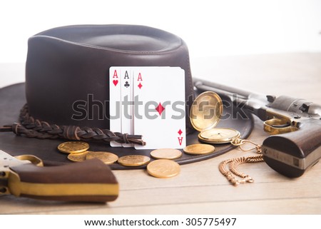 Western hat, cards, gun, gold coins