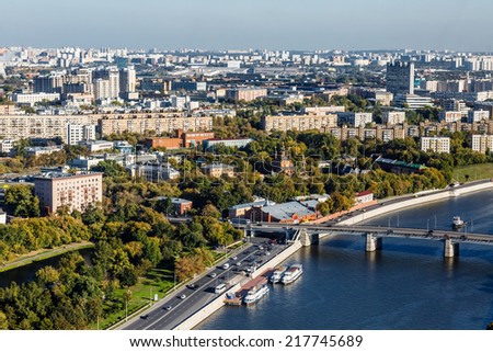 RUSSIA, MOSCOW- SEP 15: Top view of the city. Lonely church among residential quarters and the river with the ships, September 15, 2014