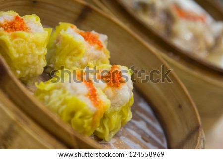 Steamed shrimp dumplings with dim sum background