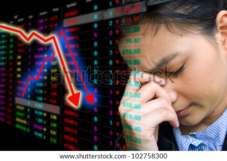 Business woman serious a falling down graph of stock market