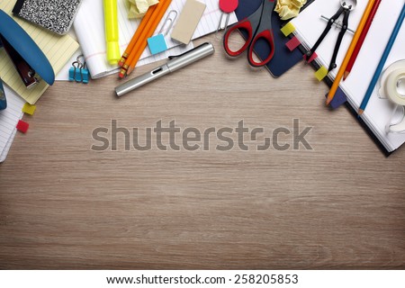 Desk cluttered with office supplies