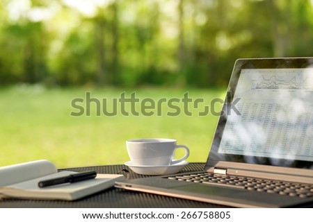 Laptop and coffee, outdoor office