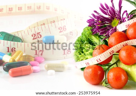 Fruits, Vegetable, Medicine and Tape Measure on White Background in Waistline and Weight Control Concept by Medicine and Food Control.