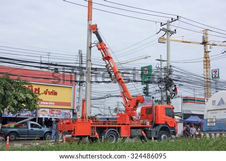 CHIANGMAI, THAILAND -SEPTEMBER 26 2015: Truck with crane of Provincial eletricity Authority of Thailand. Photo at road no.121 about 8 km from downtown Chiangmai, thailand.