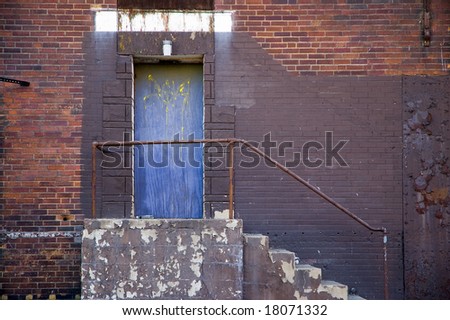 Blue Door in the side of a city building