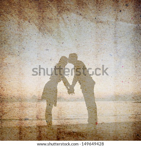 Vintage background of man is kissing his lover at her forehead on the beach