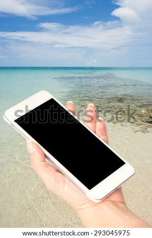 Woman hand hold Smart phone selected focus on screen on background