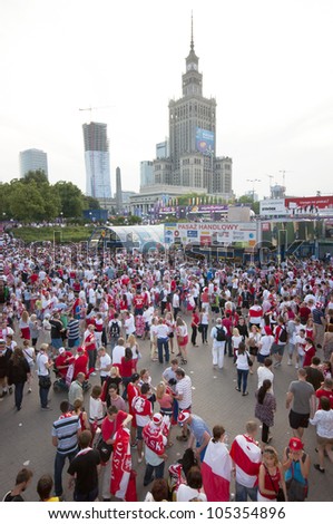 WARSAW, POLAND - JUNE 16: Polish fans at Warsaw streets before UEFA EURO 2012 Poland vs Czech Republic football match, with Palace of Science and Culture in backgorund, June 16, 2012 in Warsaw, Poland