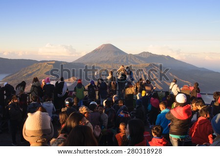 MOUNT BROMO, INDONESIA - JUNE 28, 2014: Undefined tourists watching sunrise over Bromo volcano, Tengger Semeru National Park, East Java, Indonesia on June 26, 2014