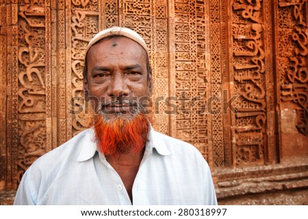 AJMER, INDIA - MARCH 06, 2013: Undefined Indian man with red beard in front of Adhai-din-ka-Jhonpra ruins in a holy Muslim city of Ajmer, India. April 06, 2013