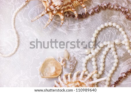 pearl necklace and seashell over stones/Jewels in a nacreous shell on a dressing table