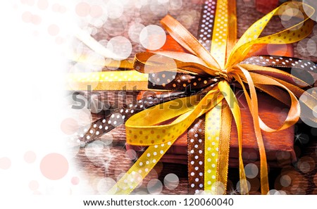 Holidays background/ Holidays present with bow from atlas ribbon/ Romantic holidays gift