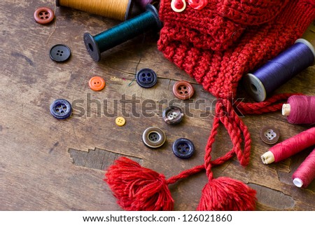 Spools of threads and buttons on old wooden table