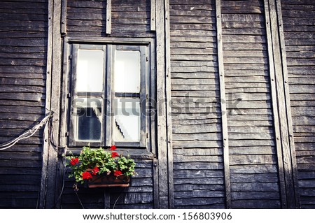 Old European Wooden Window/ The window of the old wooden log house on the background of wooden walls in vintage style