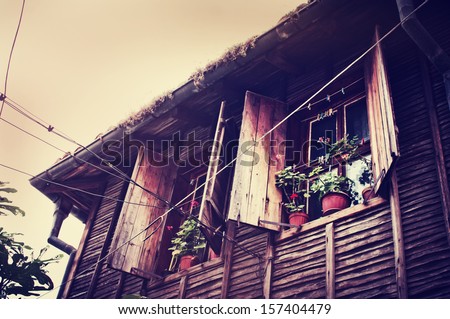 Old European Wooden Window/ The window of the old wooden log house on the background of wooden walls in vintage style