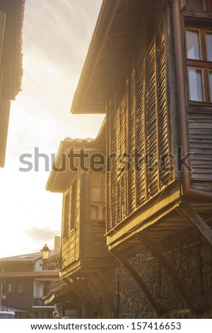 Old European Wooden Windows/ The window of the old wooden log house on the background of wooden walls in vintage style