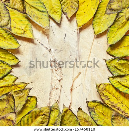 Autumn Leaves over wooden background.With copy space/autumn frame with yellow leaves