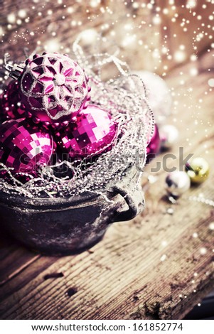 Vintage Christmas Ornament Background/ Christmas decorations in old pot on textured wooden background/ Composition with Brilliant Christmas Balls