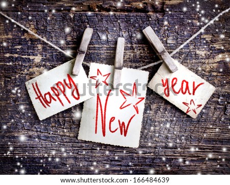 Happy New Year card with  snow on wooden background