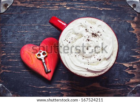 Red Cup of coffee and  heart with key on dark textured background/ Valentines day background