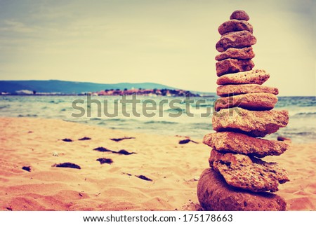 Stones balance over blue sea in vintage colors/ Summer holiday beach background/ Scene Sea Memories