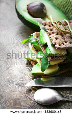 Bread sandwiches with cheese, avocado and fresh arugula - healthy eating concept