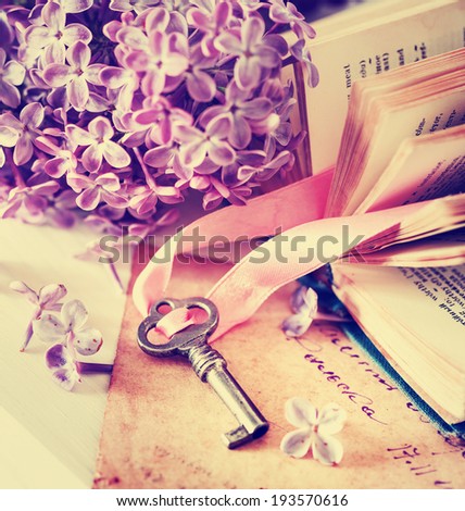 Nostalgic vintage background/ Vintage books,Photos of Memories and key with lilac flower